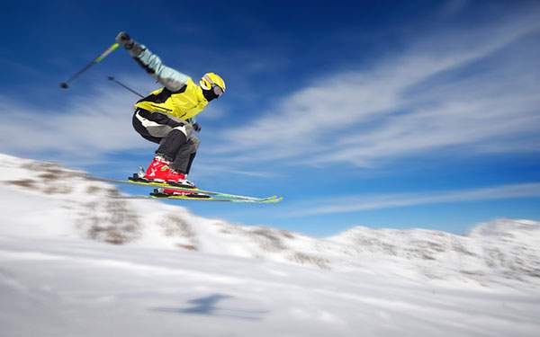 ジャンプするスキーヤーを流し撮りしたスピード感ある写真壁紙画像